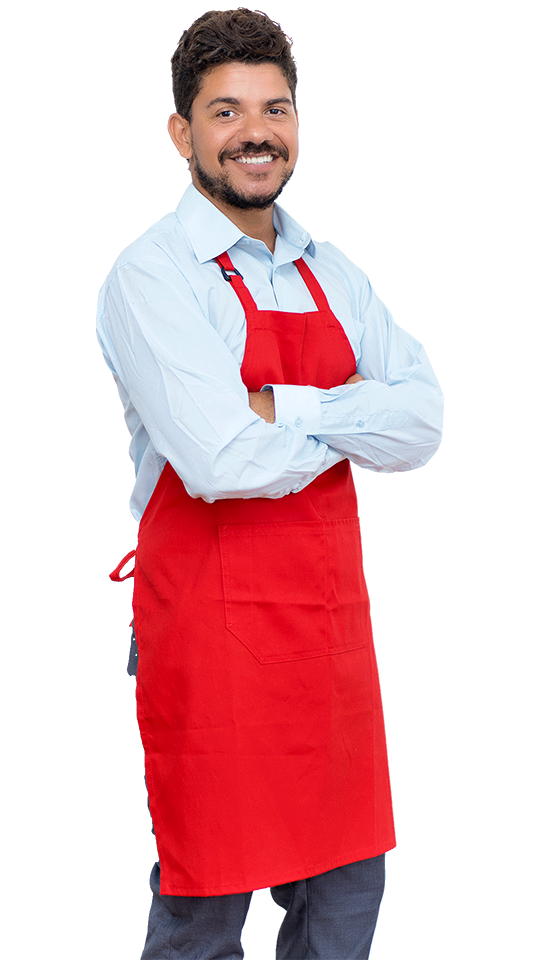 A man in a red apron with his arms crossed stands ready to deliver integrated marketing solutions.
