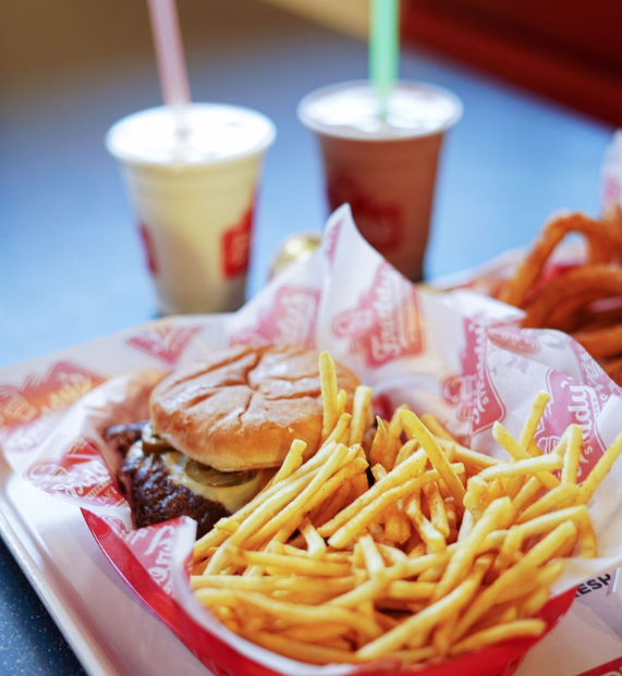 A tray with a burger, fries, and a drink, presented with Digital Marketing Expertise.