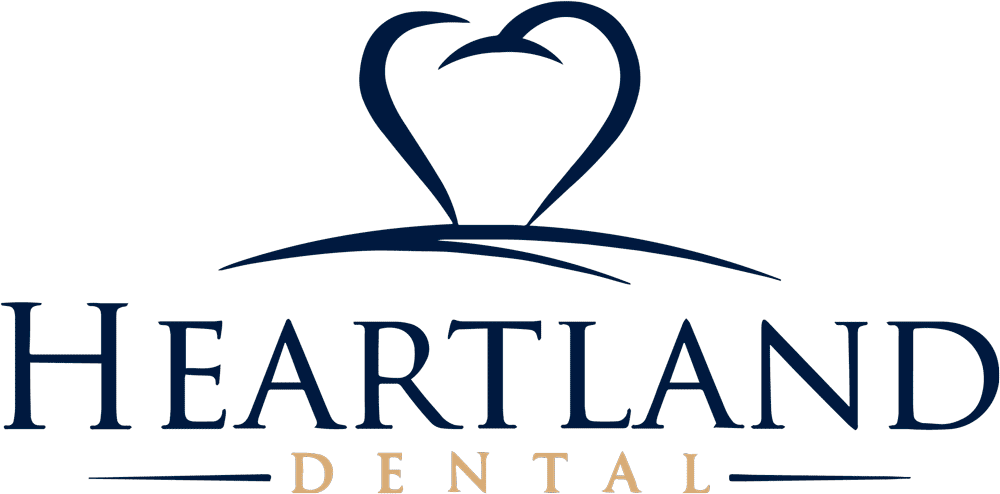 "Heartland Dental logo with a stylized heart forming a dental arch in navy blue over the company name."