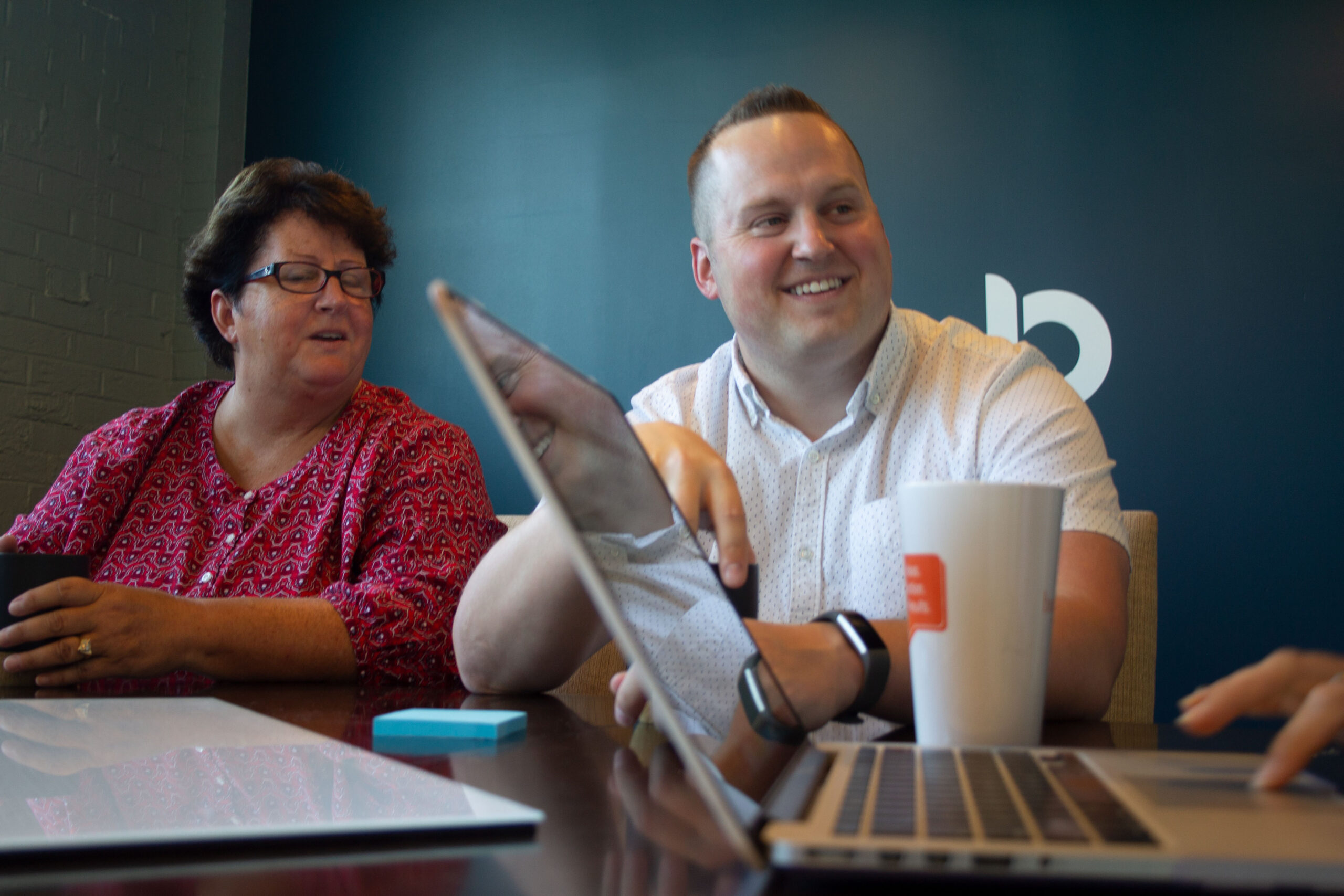 Two colleagues in a collaborative meeting at Burkhart Marketing